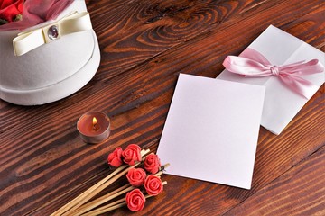 Gift box with flowers on wooden background, preparation for the holiday concept. Top view and copy area for text.