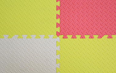 Colorful foam baby playground mat for kid. Soft mat rubber jigsaw background.