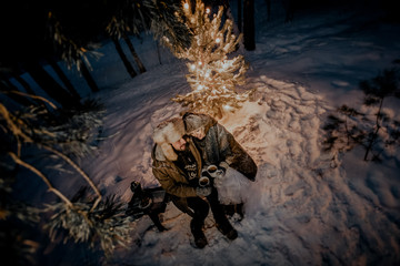 A couple of tourists a man and a woman alone in the woods at night.