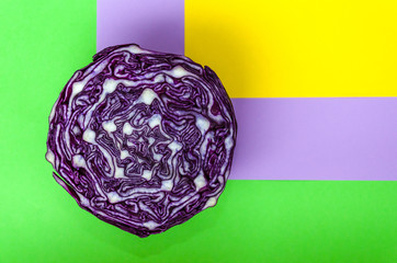 Red cabbage cross section on green, violet and yellow background. Beautiful abstract pattern. Top...