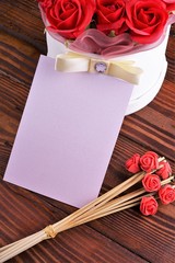 Gift box with flowers on wooden background, preparation for the holiday concept. Top view and copy area for text.