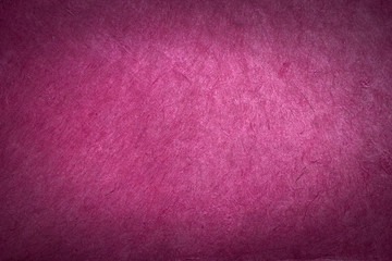 antique colored paper background texture with dark in old distressed vintage design. Colour of paper pink, christmas texture