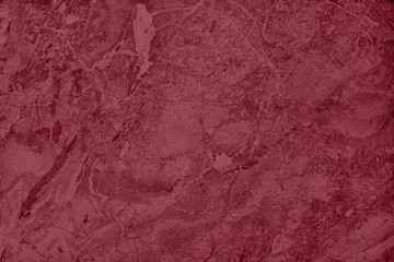 Dark red colored low contrast marble textured background with roughness and irregularities to your design or product. Color trend concept.