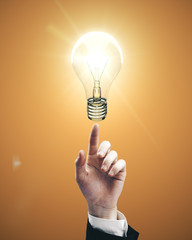 Businessman hand pointing to light bulb