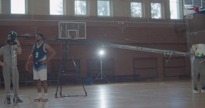 videographer taking video shots of basketball