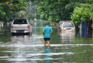 Man walking on a flooded road