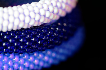 Three beaded bracelets on a dark background close up