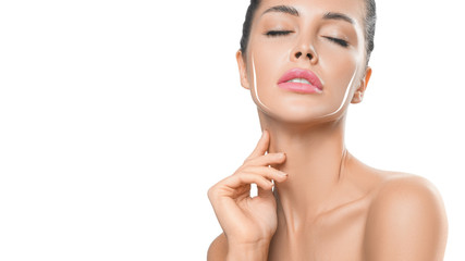 Young female touching her clean fresh skin on white background.