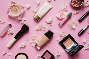 Obraz premium Make up items on pink color background. Set of luxury decorative cosmetics flat lay, top view, mockup, template. Minimal style. Beauty blogger concept.