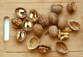 Walnuts kernels on wooden desk with color background, Whole walnuts and Half walnuts 