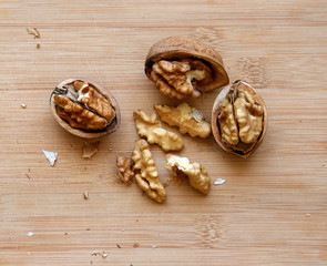 Walnuts kernels on wooden desk with color background, Whole walnuts and Half walnuts 