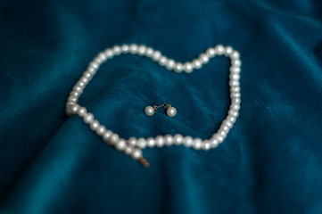 pearl necklace on blue background