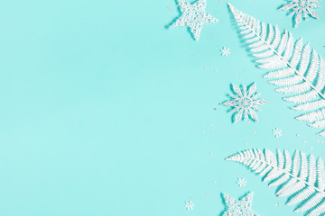 Fototapeta na wymiar Christmas composition. White decorations on pastel blue background. Christmas, winter, new year concept. Flat lay, top view, copy space