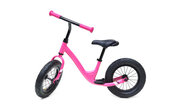 A Pink Balance Bike Isolated On White Background