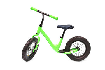 Fototapeta na wymiar A green balance bike isolated on white background