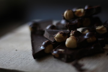 broken pieces of black chocolate with nuts