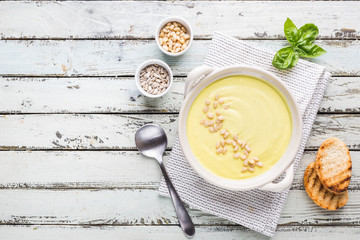 Vegetarian white cauliflower cream soup in a white bowl, top view