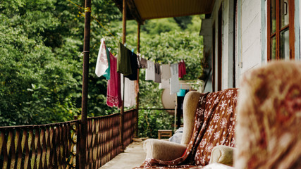 Clothes drying on rope line on a balcony - rural life. The interior of the old terrace