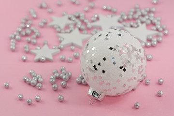 White christmas ball on light pink background.