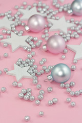 Christmas decorations on light pink background.