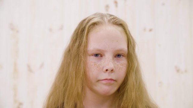 Portrait displeased girl looking with disgust to camera. Close up face disgusting girl teenager isolated in light studio. Disgusting, abominable, contempt and other negative people emotions