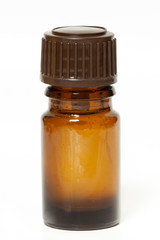 Brown glass little bottle empty or with essential oil white background