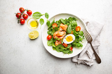 Salad with spinach, Salmon and eggs. Healthy home made food. Concept for a tasty and healthy meal. Top view. Copy space.