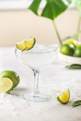 Refreshing Homemade Classic Alcoholic Margarita Cocktail with Lime and Salt on light background