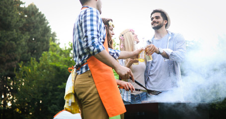 Handsome male preparing barbecue and havinf fun together