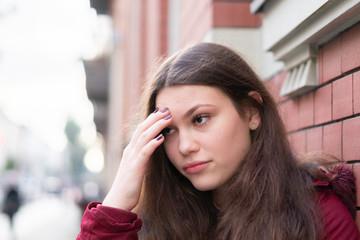 Woman with head on her forehead thinking or in pain