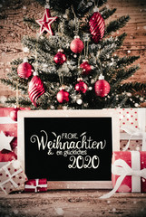 German Calligraphy Frohe Weihnachten Und Ein Glueckliches 2020 Means Merry Christmas And A Happy 2020. Christmas Tree With Gifts, Red Ball Ornament And Sowflakes
