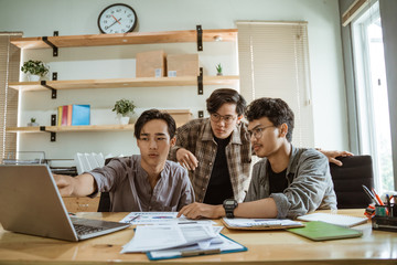 portrait of asian creative team working together in the contemporary design office