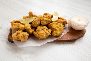 Homemade crispy japanese fried chicken Karaage on a rustic wooden board, low angle view. Close-up.