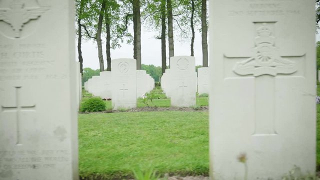 Headstones at war cemetery Oosterbeek closeup dollyshot