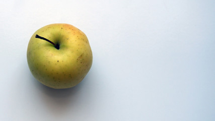 Organic yellow apple on a white background