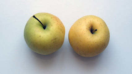Organic yellow apple on a white background