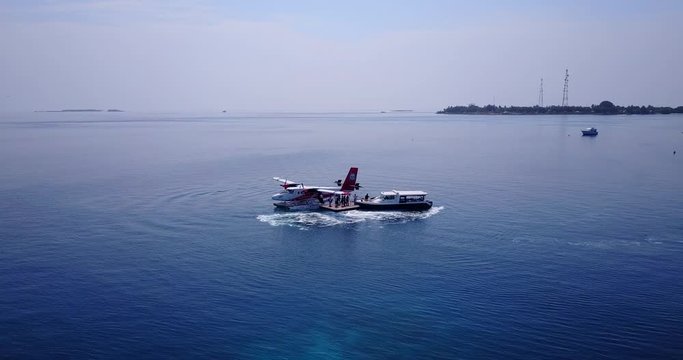 Tonga Island - A Seaplane In The Middle Of The Ocean Being Checked By Engineers - Panoramic Shot