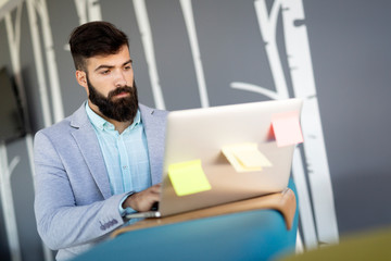 Portrait of young man sitting at desk in the office