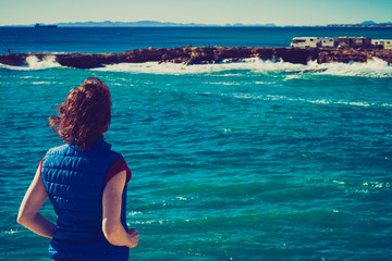 Tourist woman on sea cliffs in Spain