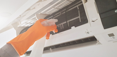 Modern airconditioner unit service cleaning the filter to prevent respiratory disease.