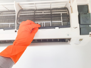 Modern airconditioner unit service cleaning the filter to prevent respiratory disease.