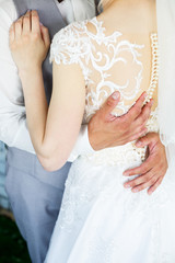 Obraz na płótnie Canvas Bride and groom hugging on a wedding day