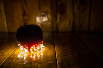 Red Apple on wood, with warm light
