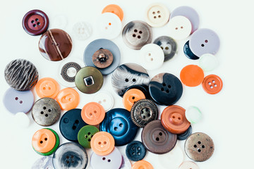 Fototapeta na wymiar Colorful sewing buttons on white background closeup with copy space for text.