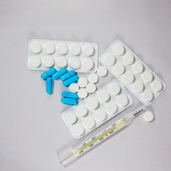 Medication and thermometer for measuring body temperature.