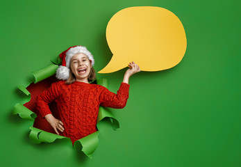 girl in Santa's hat on bright color background