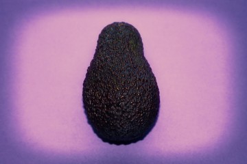 ripe avocado on lilac background