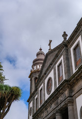 San Cristobal de La Laguna, Tenerife, Spain. Antique style building on a cloudy blue sky background. Colonial style of the city. Houses painted with various bright colors.