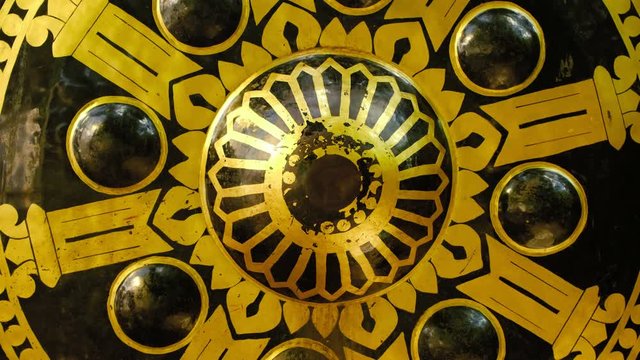 Hitting the oriental gong in thai buddhist temple