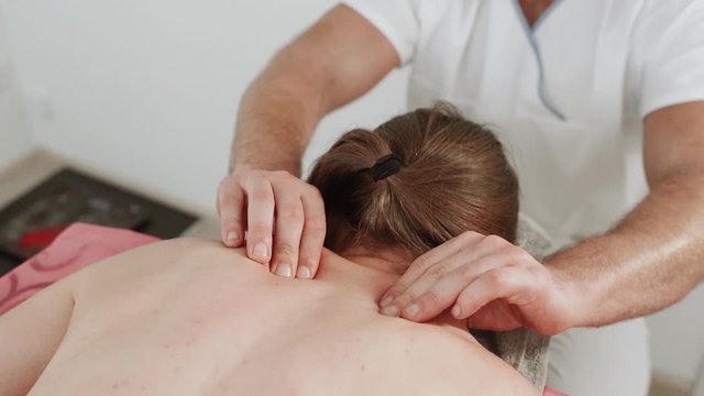 Massage concept. Beautiful young woman reciving relxing massage